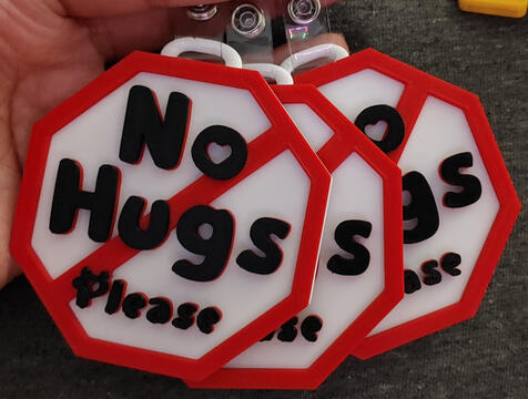 Multi-layered Black, red & white hug consent badges